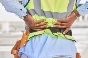 A construction worker at a non-union construction site injures himself lifting a heavy object