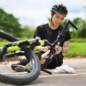 Cyclist injured in a Queens bicycle accident being helped by emergency responders.