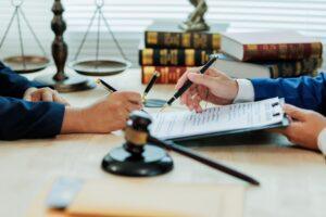 An attorney walks his client through documentation that explains what to do after losing a loved one in an accident.