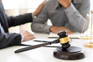 An attorney speaks with a client after explaining how wrongful death claims work in New York. The estate’s personal representative must file the lawsuit to show that another party caused the death.