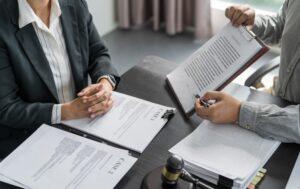 A lawyer discusses the average semi-truck accident settlement on Long Island with her clients.