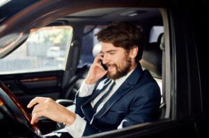 A man talks on the phone while driving. A lawyer can tell you what to do after a distracted driving accident in New York.