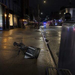 Delivery e-bike lying near the curb on a Brooklyn avenue at night