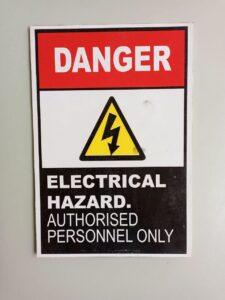 A sign warning of electrical hazards. Learn about the common causes of electrocution injuries at work on Long Island.